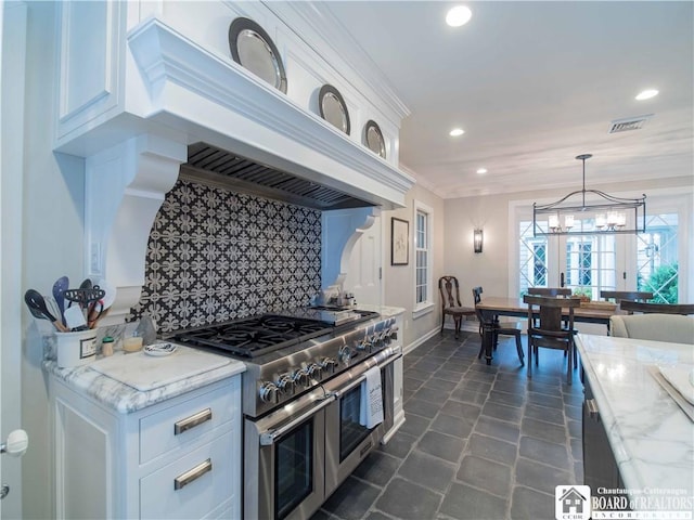 kitchen with backsplash, visible vents, range with two ovens, recessed lighting, and white cabinetry
