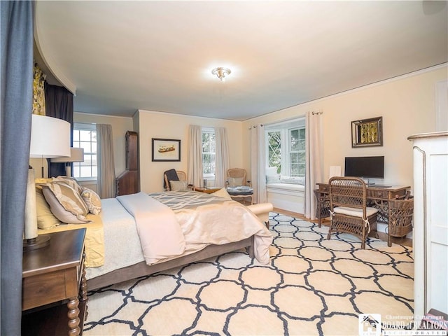 bedroom with crown molding and multiple windows