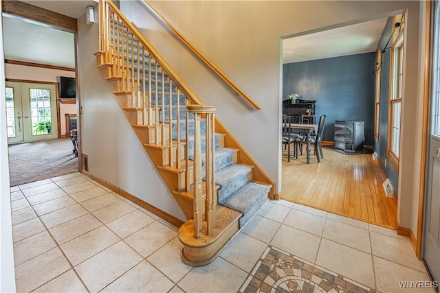 2575 Fuller Rd, Newfane, NY 14028 - stairs featuring tile patterned floors, baseboards, french doors, and visible vents