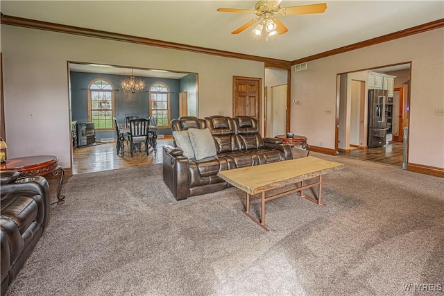 2575 Fuller Rd, Newfane, NY 14028 - carpeted living area featuring visible vents, ornamental molding, baseboards, and ceiling fan with notable chandelier