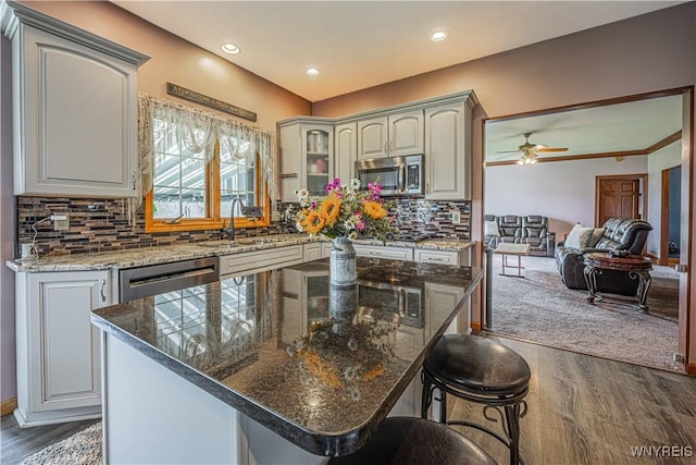 2575 Fuller Rd, Newfane, NY 14028 - kitchen featuring a sink, a ceiling fan, stainless steel appliances, and dark wood-type flooring