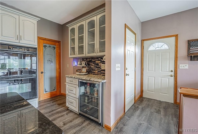 2575 Fuller Rd, Newfane, NY 14028 - kitchen with beverage cooler, dobule oven black, dark wood-style floors, and glass insert cabinets