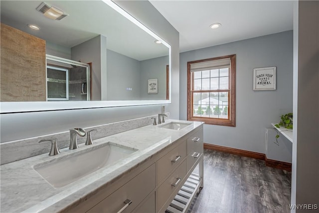 2575 Fuller Rd, Newfane, NY 14028 - full bath with a sink, baseboards, wood finished floors, and visible vents