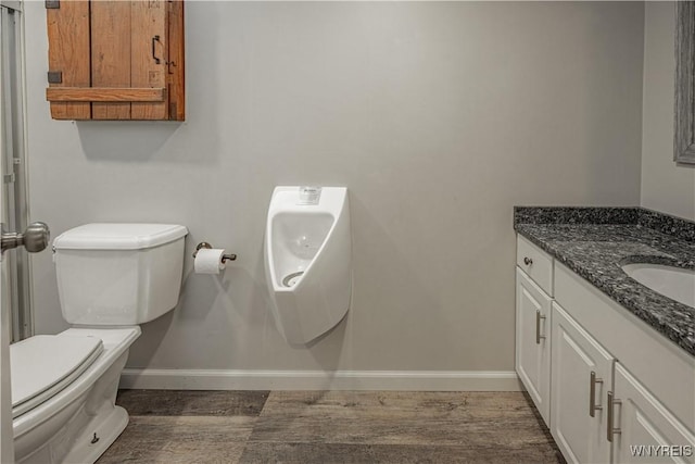 2575 Fuller Rd, Newfane, NY 14028 - bathroom featuring toilet, baseboards, wood finished floors, and vanity