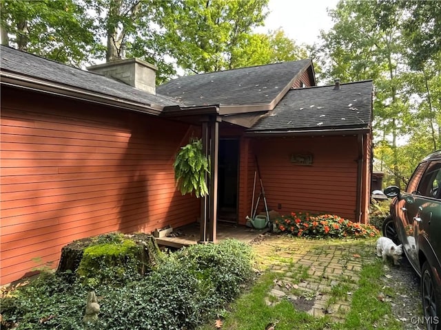 2321 Olanco Rd, Spafford, NY 13110 - view of side of home featuring roof with shingles and a chimney