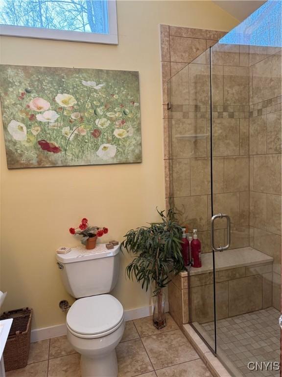 2321 Olanco Rd, Spafford, NY 13110 - bathroom featuring baseboards, tile patterned flooring, a shower stall, and toilet