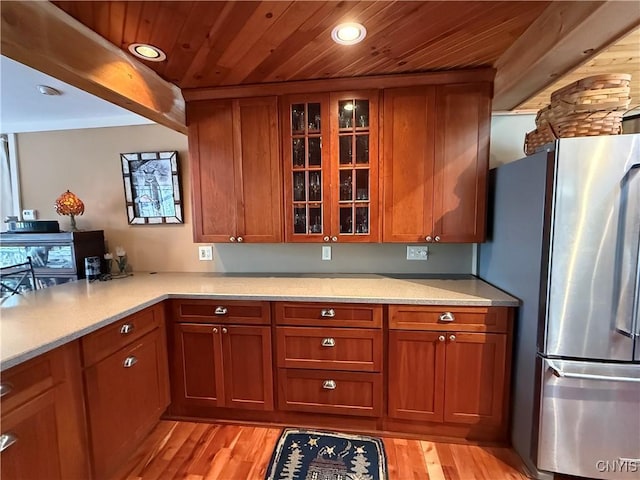 2321 Olanco Rd, Spafford, NY 13110 - kitchen with freestanding refrigerator, brown cabinetry, wood ceiling, recessed lighting, and light countertops