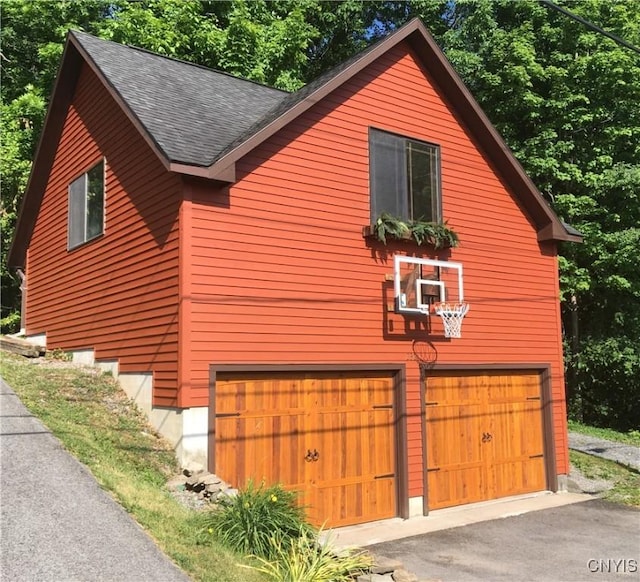 2321 Olanco Rd, Spafford, NY 13110 - view of property exterior featuring a garage and a shingled roof