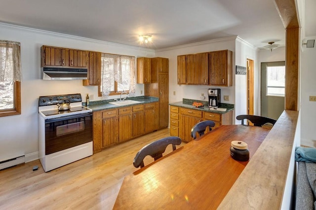 kitchen with under cabinet range hood, electric range, and brown cabinetry