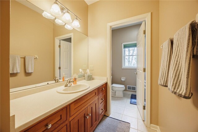 bathroom featuring visible vents, tile patterned flooring, toilet, and vanity