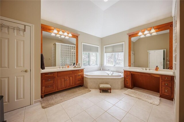 full bath featuring tile patterned floors, two vanities, a sink, and a garden tub