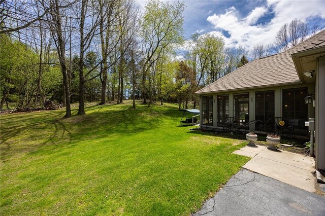 view of yard featuring a sunroom
