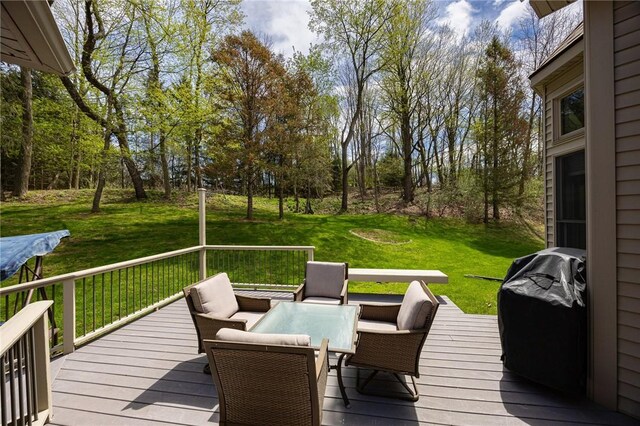 wooden terrace featuring an outdoor hangout area and a yard