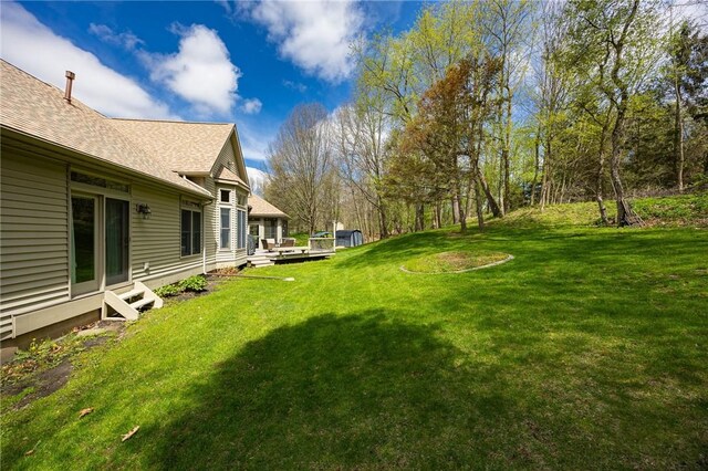 view of yard featuring a wooden deck and entry steps