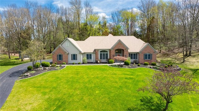 ranch-style home with brick siding and a front lawn