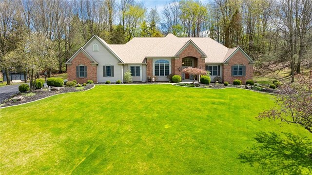 single story home featuring brick siding and a front lawn