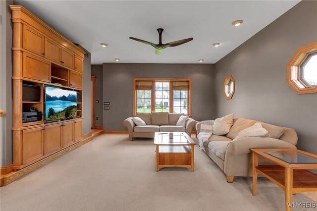 living room featuring baseboards, ceiling fan, light carpet, and recessed lighting