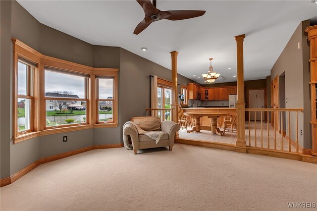 living area featuring baseboards, recessed lighting, ceiling fan with notable chandelier, and light carpet