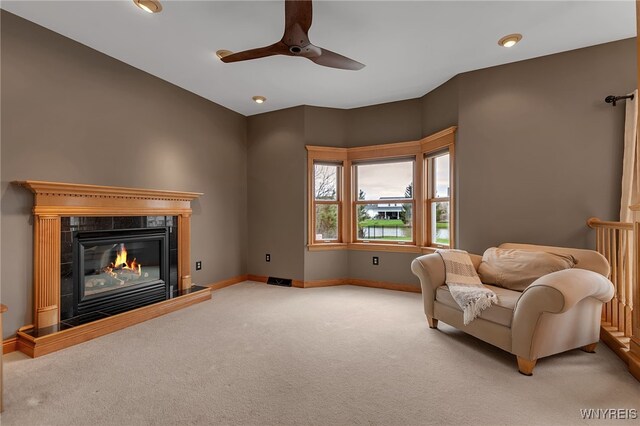 sitting room featuring baseboards, ceiling fan, recessed lighting, a high end fireplace, and carpet