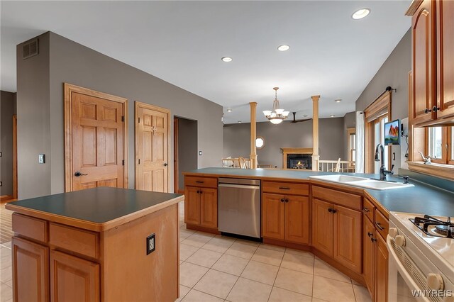 kitchen featuring a sink, a peninsula, dishwasher, white gas range oven, and light tile patterned floors