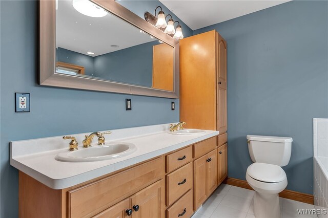 full bath featuring double vanity, toilet, a sink, and tile patterned flooring