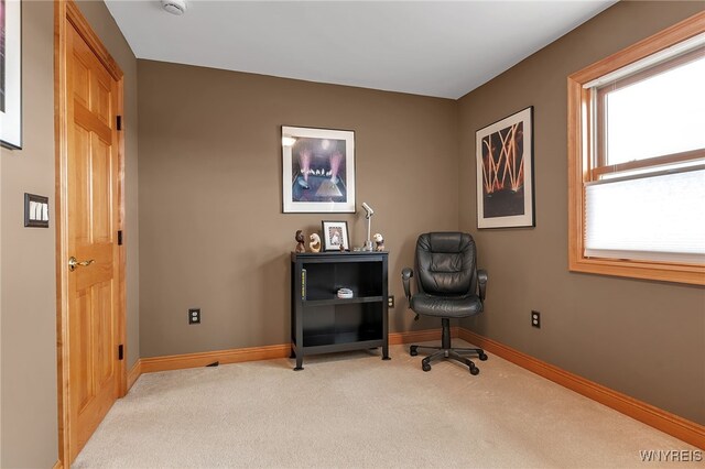 office with baseboards and light carpet