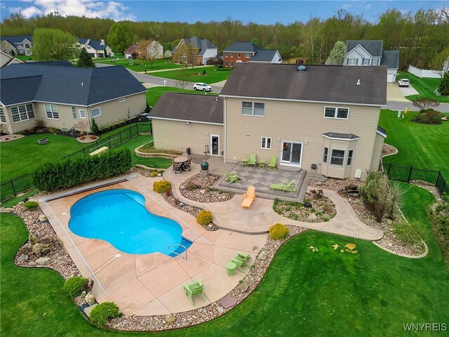 view of swimming pool featuring a fenced backyard, a fenced in pool, a patio, and a lawn