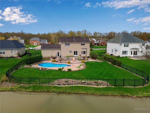 back of house featuring a residential view, a patio, a yard, and a fenced backyard
