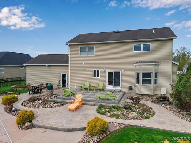 back of property with a patio and fence