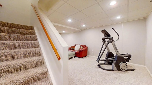 exercise room with carpet flooring, recessed lighting, baseboards, and a paneled ceiling