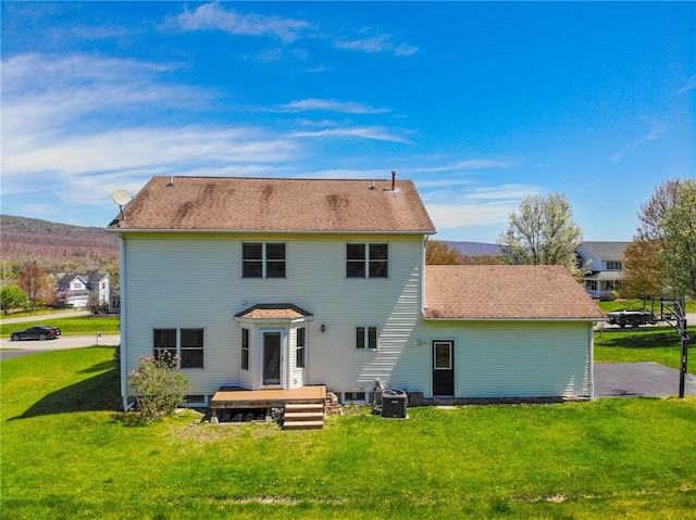 back of property with a yard and cooling unit
