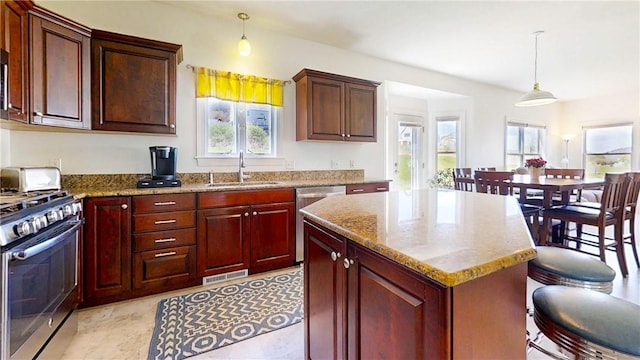 kitchen with stainless steel appliances, visible vents, a healthy amount of sunlight, and a sink