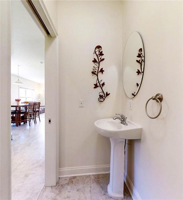 bathroom with baseboards and a sink