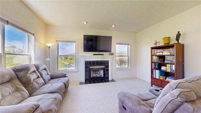 living room with a fireplace, baseboards, carpet, and recessed lighting