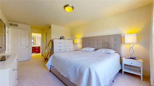 bedroom with visible vents and light carpet
