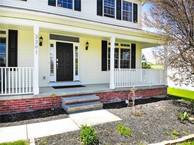 view of exterior entry with a porch
