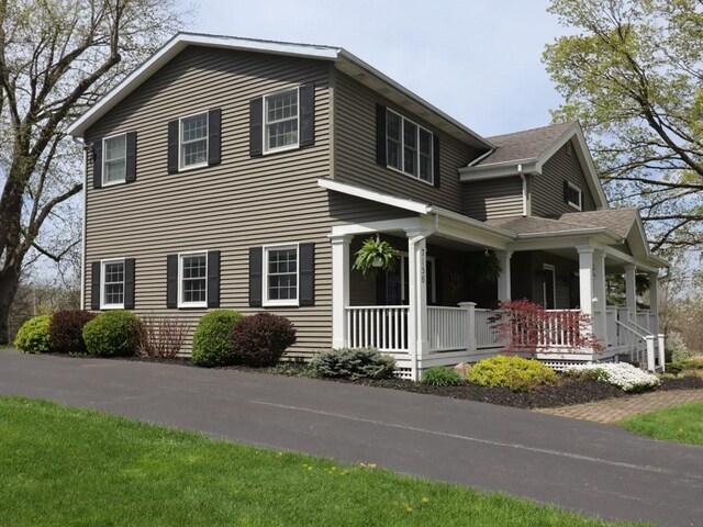 view of side of home with a porch
