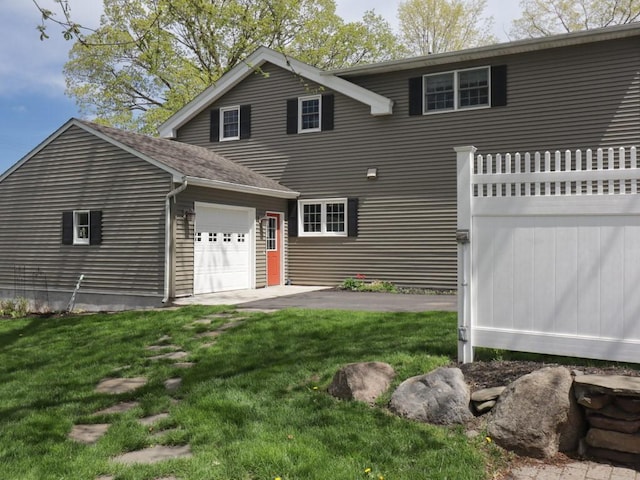 view of front of property with a garage and a front lawn