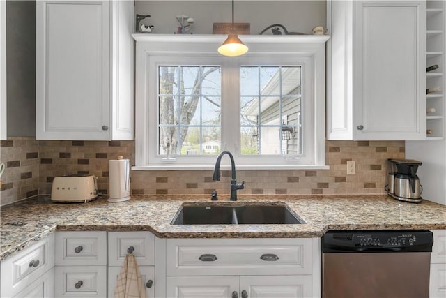 kitchen with a sink, white cabinetry, and dishwasher