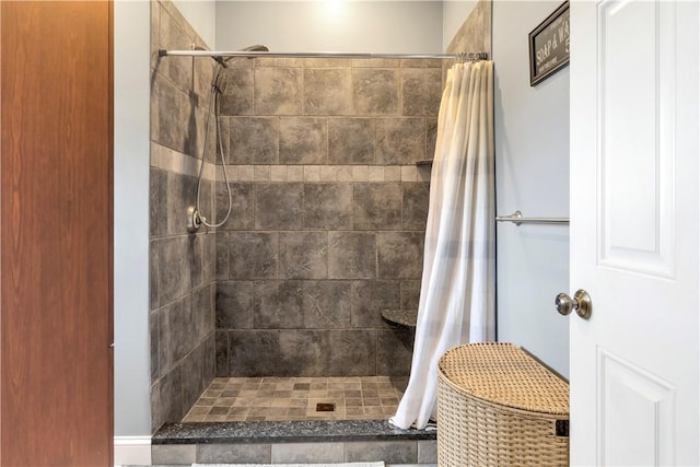full bath with a tile shower