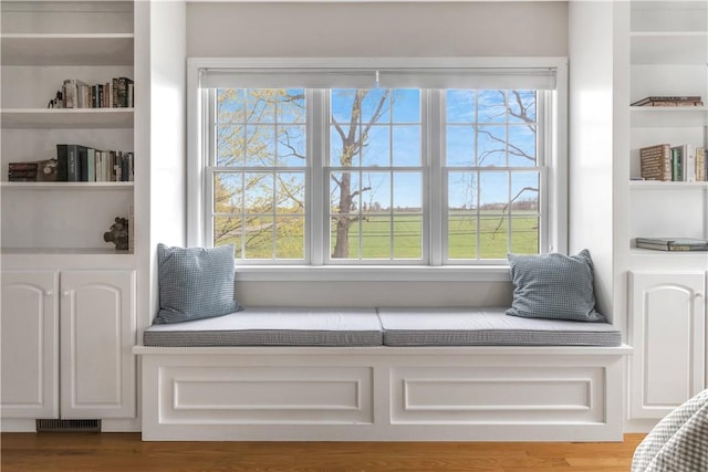 living area featuring visible vents and built in shelves
