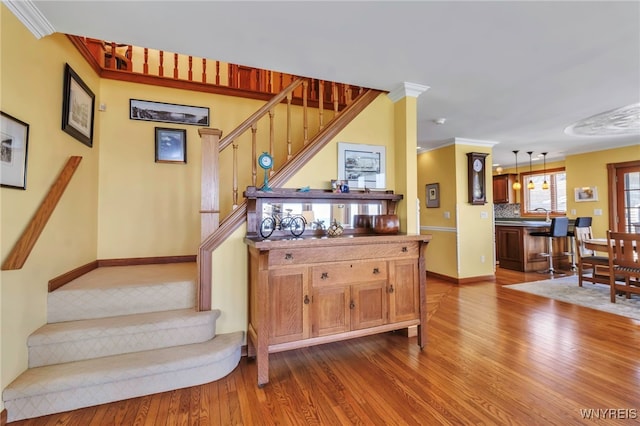 5561 Lockwood Hts, Newfane, NY 14126 - staircase with wood finished floors and ornamental molding