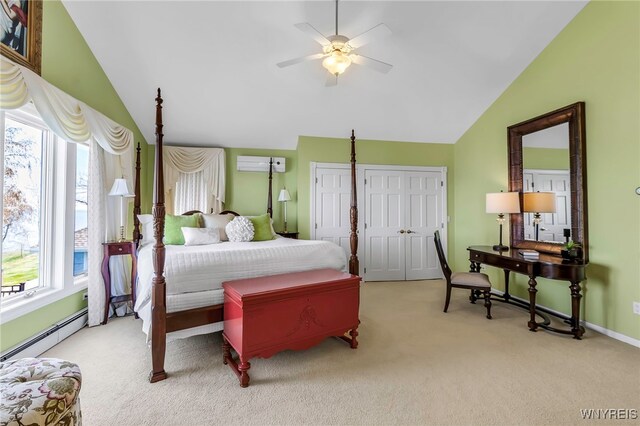 carpeted bedroom with two closets, baseboard heating, a wall mounted AC, a ceiling fan, and vaulted ceiling