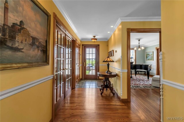 hall featuring french doors, crown molding, a chandelier, recessed lighting, and dark wood-type flooring