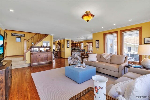living area featuring crown molding, recessed lighting, and stairs