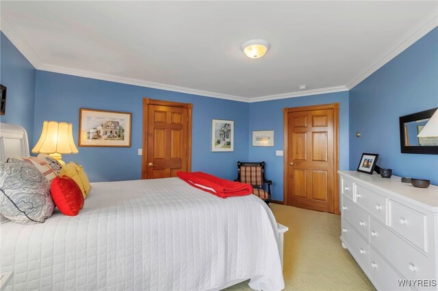 bedroom with ornamental molding and light carpet