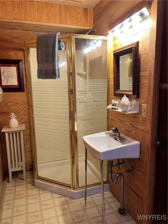 bathroom featuring a sink, tile patterned floors, and a shower stall