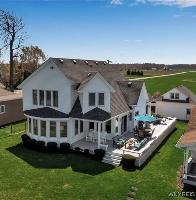 5561 Lockwood Hts, Newfane, NY 14126 - back of property featuring roof with shingles, a lawn, and a patio area