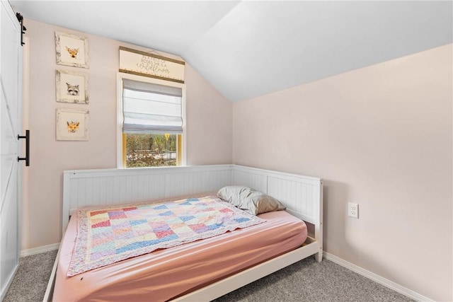 carpeted bedroom featuring baseboards and vaulted ceiling