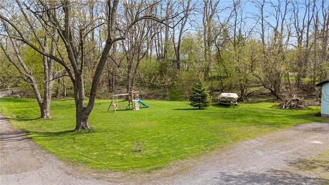 surrounding community featuring a playground and a lawn